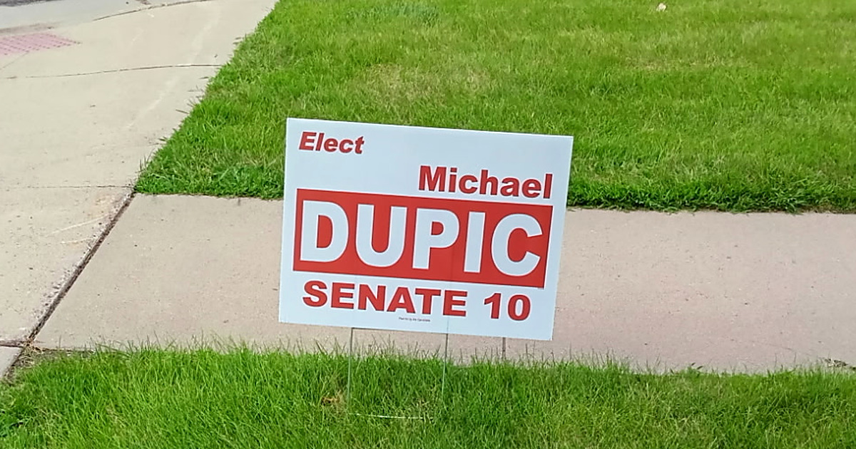 An Elect Michael Dupic, Senate 10 yard sign standing in a front yard in District 10, Sioux Falls